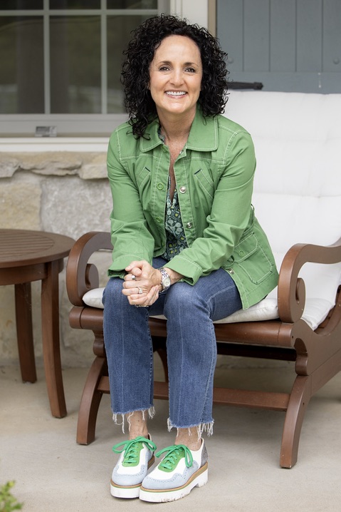 Julie James, functional health practitioner sitting on a chair on the porch